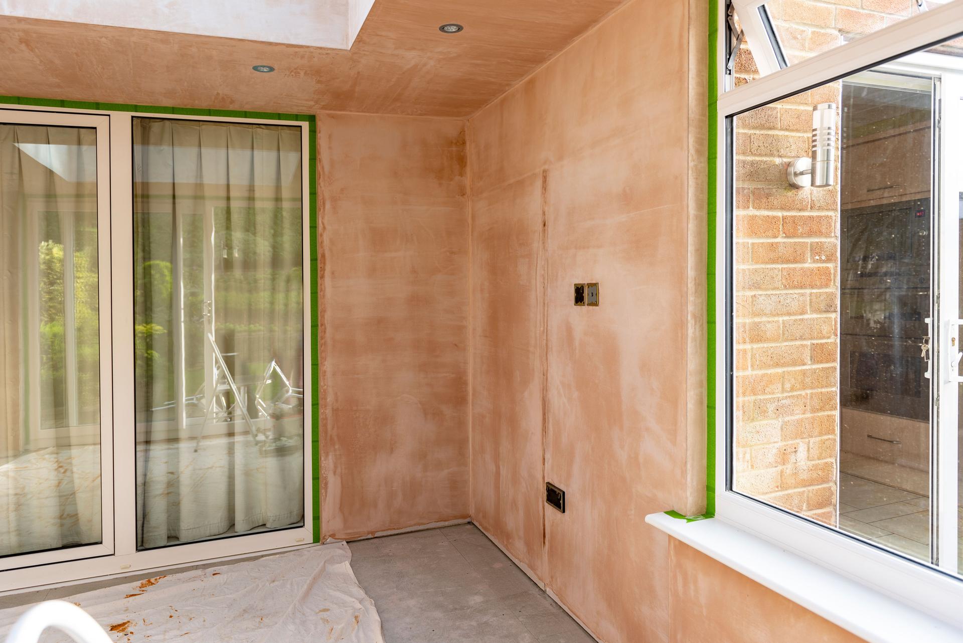 Orangery style conservatory nearing completion after plaster has been applied to the interior walls.