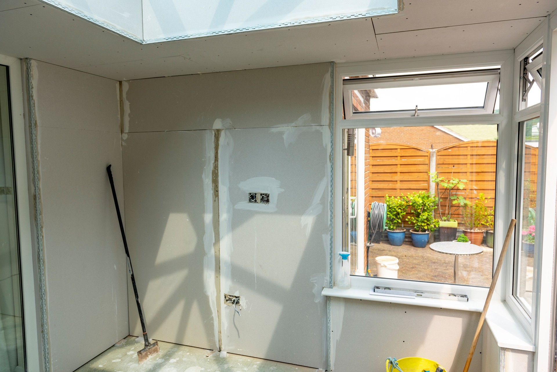 Plasterboard walls of a conservatory ready for plastering.